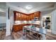 The beautiful kitchen features custom wood cabinets, stainless steel appliances, and an island with a dining table at 118 Whitestone Dr, Mcdonough, GA 30253