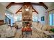 Vaulted living room boasts stone fireplace, wood beams, and an abundance of natural light at 118 Whitestone Dr, Mcdonough, GA 30253