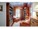 Cozy sitting room with window seat, custom bookshelves, and seating for reading and relaxation at 118 Whitestone Dr, Mcdonough, GA 30253