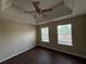 Bright bedroom with tray ceilings, neutral walls, wood floors and large windows for natural light at 257 Juliet Dr, Hampton, GA 30228