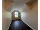 Bedroom with neutral walls, wood floors, white trim, a vaulted ceiling and a window for natural light at 257 Juliet Dr, Hampton, GA 30228