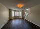 Open living area featuring hardwood floors, bright windows, and a staircase at 257 Juliet Dr, Hampton, GA 30228