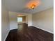Spacious living room featuring hardwood floors and neutral paint, leading into the dining room at 257 Juliet Dr, Hampton, GA 30228