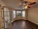 Bright room featuring hardwood floors, a modern ceiling fan, and lots of natural light at 257 Juliet Dr, Hampton, GA 30228