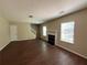 Spacious living room with hardwood floors, a fireplace, and natural light at 257 Juliet Dr, Hampton, GA 30228