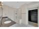 Bright bathroom featuring a double vanity, modern tub and adjacent closet at 44 Peachtree Nw Pl # 2024, Atlanta, GA 30309