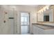 Stylish bathroom with a glass-enclosed shower, granite vanity, and elegant gold fixtures at 44 Peachtree Nw Pl # 2024, Atlanta, GA 30309