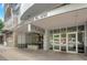 Welcoming entrance to the building, featuring modern architecture and prominent signage at 44 Peachtree Nw Pl # 2024, Atlanta, GA 30309