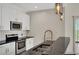 Contemporary kitchen featuring stainless steel appliances, granite countertops, and modern fixtures at 44 Peachtree Nw Pl # 2024, Atlanta, GA 30309