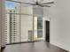 Bright living space with large windows offering city views and dark hardwood floors at 44 Peachtree Nw Pl # 2024, Atlanta, GA 30309