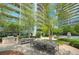 Inviting outdoor grilling area with ample seating and a view of the building's balconies at 44 Peachtree Nw Pl # 2024, Atlanta, GA 30309
