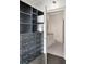 This walk-in closet with built-in shelving and plenty of drawers connects to an en-suite bathroom at 44 Peachtree Nw Pl # 2024, Atlanta, GA 30309