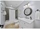 Well-lit bathroom with a shower-tub combo, modern vanity, and neutral tile flooring at 66 Mobile Ne Ave, Atlanta, GA 30305