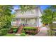 Charming two-story home boasts a welcoming front porch, landscaped yard, and classic architectural details at 66 Mobile Ne Ave, Atlanta, GA 30305
