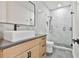 Modern bathroom featuring a vessel sink, walk-in shower with glass door, and gray tile at 1240 Hayes Sq, Peachtree City, GA 30269