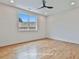 Upstairs bedroom with hardwood floors, a ceiling fan, and a large window at 1240 Hayes Sq, Peachtree City, GA 30269