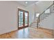 Entryway view of stairs with iron railing and wood double doors overlooking front yard at 1240 Hayes Sq, Peachtree City, GA 30269