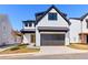 Modern two-story home featuring painted brick, black trim, and a front-entry two car garage at 1240 Hayes Sq, Peachtree City, GA 30269