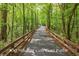 Golf cart path surrounded by trees on both sides and a wooden fence at 1240 Hayes Sq, Peachtree City, GA 30269