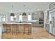 Open kitchen with gray cabinets, large kitchen island, and modern stainless steel appliances at 1240 Hayes Sq, Peachtree City, GA 30269