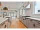 A modern kitchen features stainless steel appliances, an island, and custom cabinets at 1240 Hayes Sq, Peachtree City, GA 30269