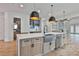 Spacious kitchen features a central island, stainless steel appliances, and modern pendant lighting at 1240 Hayes Sq, Peachtree City, GA 30269