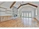 Open living room with wood beams, fireplace, built-ins and access to the backyard at 1240 Hayes Sq, Peachtree City, GA 30269