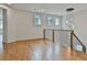 Second floor loft area with hardwood floors, modern chandelier, and natural light at 1240 Hayes Sq, Peachtree City, GA 30269