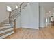 Open staircase with wood treads, modern metal railing, and light hardwood floors at 1240 Hayes Sq, Peachtree City, GA 30269