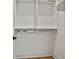 Bright walk-in closet offering hardwood floors and white shelving with ample storage at 1240 Hayes Sq, Peachtree City, GA 30269