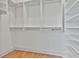 Organized walk-in closet with custom white shelves and rods for efficient storage at 1240 Hayes Sq, Peachtree City, GA 30269
