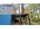 Exterior view of a wooden deck supported by posts with stairs and gray siding at 1285 North Nw Ave, Atlanta, GA 30318