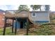 View of the back of the house with a deck, basement entrance, and gray siding at 1285 North Nw Ave, Atlanta, GA 30318