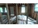 Bedroom in the middle of construction with exposed wood, a new door and natural light from multiple windows at 1285 North Nw Ave, Atlanta, GA 30318
