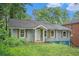 Single-story home boasting neutral siding, rustic shutters and covered entryway at 1285 North Nw Ave, Atlanta, GA 30318