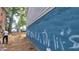 View of the blue foundation with graffiti, in need of maintenance and cleaning at 1285 North Nw Ave, Atlanta, GA 30318