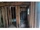 An unfinished interior with exposed framing, a tub, and a small window providing natural light at 1285 North Nw Ave, Atlanta, GA 30318