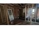 An unfinished interior with exposed wood framing, a door, and plumbing visible, with natural light at 1285 North Nw Ave, Atlanta, GA 30318
