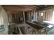 An unfinished interior with exposed wood framing, doors, and natural light filtering through windows at 1285 North Nw Ave, Atlanta, GA 30318