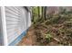 Exterior side view of the house and nearby hillside with dense trees at 1285 North Nw Ave, Atlanta, GA 30318