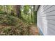 Exterior side view of the house near a hillside with dense trees at 1285 North Nw Ave, Atlanta, GA 30318
