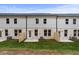 Backyard view of townhomes with patios and fenced-in yards at 504 Amethyst Way, Stockbridge, GA 30281