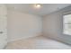 Bright bedroom with plush carpeting and a window at 504 Amethyst Way, Stockbridge, GA 30281