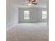 Spacious bedroom featuring neutral carpet, a ceiling fan, and lots of natural light at 504 Amethyst Way, Stockbridge, GA 30281