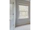 Bedroom featuring a white trimmed window, door, and neutral carpet flooring at 504 Amethyst Way, Stockbridge, GA 30281