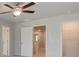 Bedroom with a ceiling fan, view into hall, and walk in closet at 504 Amethyst Way, Stockbridge, GA 30281