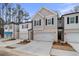 New townhomes with light colored brick, garages, and newly installed landscaping provide an inviting exterior at 504 Amethyst Way, Stockbridge, GA 30281