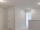 Bright carpeted hallway with a door and access to another room at 504 Amethyst Way, Stockbridge, GA 30281