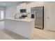 Modern kitchen featuring quartz island, stainless steel appliances and ample cabinet space, perfect for cooking at 504 Amethyst Way, Stockbridge, GA 30281