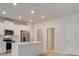 Modern kitchen with stainless steel appliances, island, and bright white cabinets at 504 Amethyst Way, Stockbridge, GA 30281